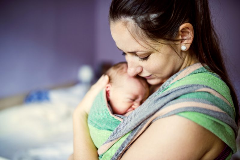 Mother wearing newborn